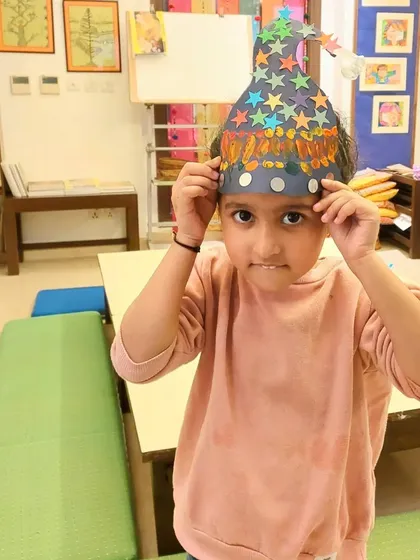 Trying on a handmade wizard hat from our Halloween workshop. These simple paper crafts are a great way for kids to get creative and celebrate the holiday.