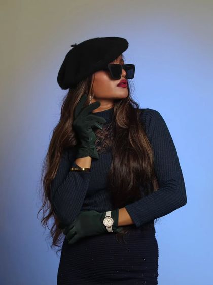 A chic and stylized studio portrait. The use of sunglasses and a beret creates a cool, retro-inspired fashion photograph.
