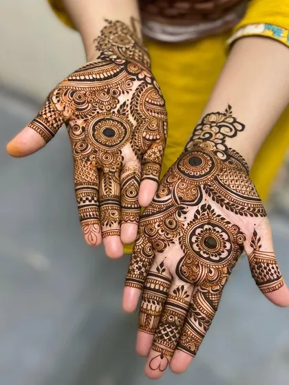 Two hands with similar but not identical designs, showcasing a mix of mandalas and other traditional patterns. Perfect for a bride and her sister or best friend.