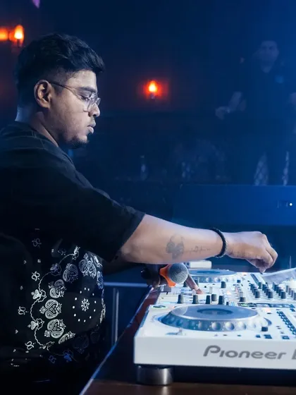 Another angle of me at work, showing my hands on the Pioneer DJ mixer. This is where the technical skill of beat-matching and mixing comes into play.