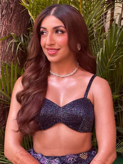 Sheena's sangeet look from another angle, showing off her voluminous waves and the radiant glow on her collarbones, an important detail for an off-shoulder top.