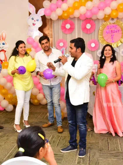 Leading a balloon game for the adults at a 'Some Bunny is One' first birthday party in Bangalore. My goal is to make sure everyone feels included and has a chance to participate.