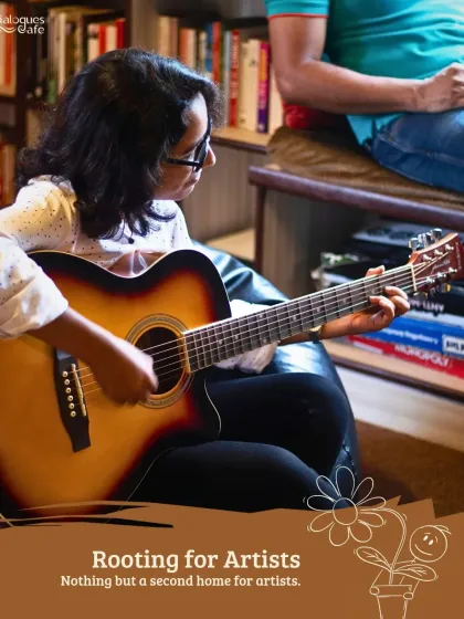 A musician strums her guitar in our cozy library corner, a perfect example of how we are always "Rooting for Artists."