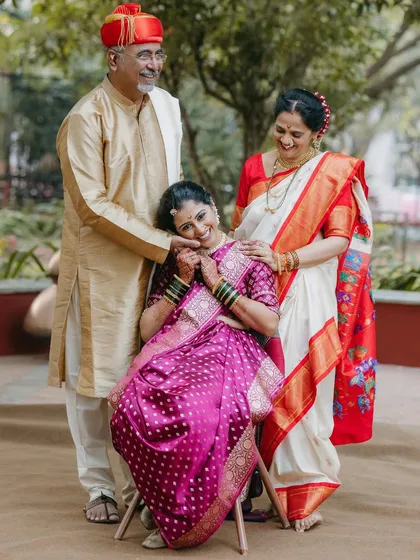 A heartwarming portrait of a Maharashtrian bride with her parents, capturing a moment of love and blessing.