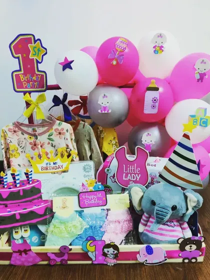 Celebrating a first birthday is a precious moment. This hamper for a little one includes baby clothes, a soft toy elephant, and adorable themed decorations to make their very first birthday party extra special.
