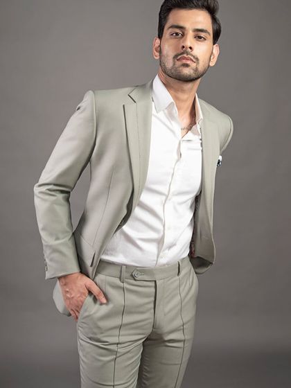 A modern take on the business suit in a light sage green. Paired with a crisp white shirt, this two-piece suit offers a fresh yet professional look.