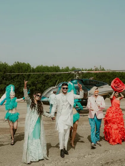 A grand entrance that sets the tone for an epic celebration. The couple arrives by helicopter, greeted by performers, a moment of pure spectacle that I capture to tell the story of a truly unique wedding.