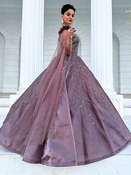 A full-length shot of the mauve gown, capturing its impressive volume and elegant drape.