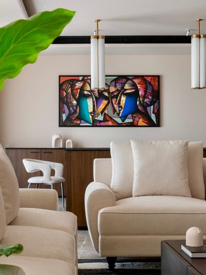 In the Parishram residence, we use art to define spaces. This vibrant, abstract painting adds a bold splash of color to the neutral living room palette.