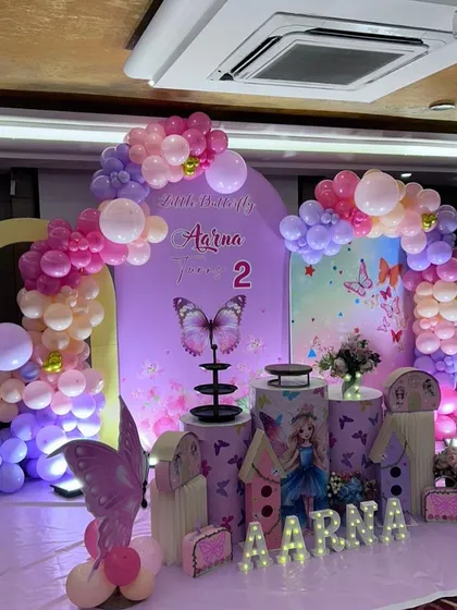 Another angle of the enchanting butterfly party decor, highlighting the layered backdrops and full balloon arches that create a sense of depth and wonder.