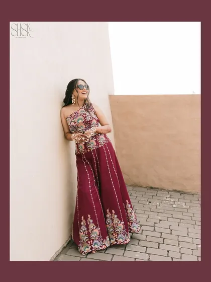 A solo shot of the bride, Shreya, looking effortlessly chic in her sunglasses and embroidered outfit.