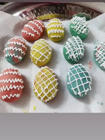 For Easter, I made these colorful egg-shaped treats. They are decorated with a white chocolate drizzle, making them a festive and fun dessert for the holiday.