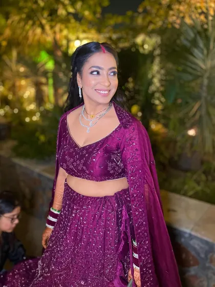 Minimalism at its best for our gorgeous reception bride. The purple eyeshadow adds a pop of color to her elegant look.