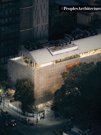 An evening aerial shot of MAP, highlighting its glowing presence in the neighborhood.