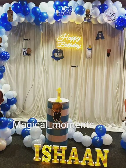 A classic Boss Baby theme with a balloon arch against a white curtain backdrop. The light-up name and character cutouts make it a perfect photo corner.