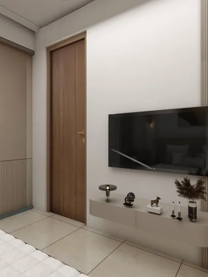 A simple yet elegant bedroom setup with a floating TV console and handleless wardrobe. The neutral tones and clean lines create a restful and uncluttered space.