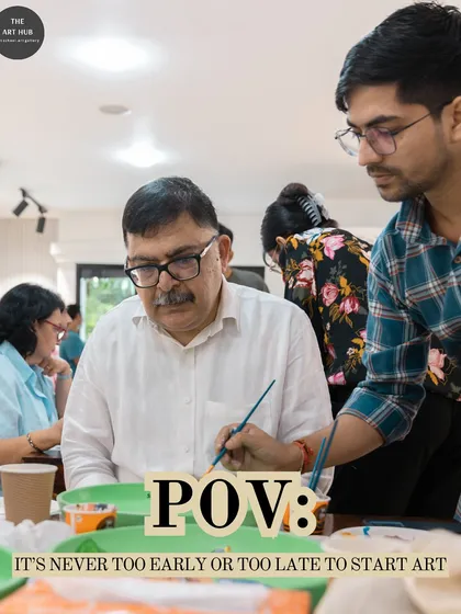 An instructor provides gentle guidance to an adult student during a plate painting workshop. My classes are designed to be supportive, regardless of your skill level.