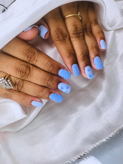 Get cozy with this sweater nail art. This design uses a special technique to create a 3D knitted texture, complete with cute hearts.