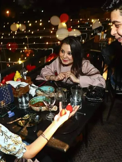 A guest is left amazed as a small red ball appears in her own hand. My goal is to make the audience the hero of the show, letting them experience the magic firsthand.