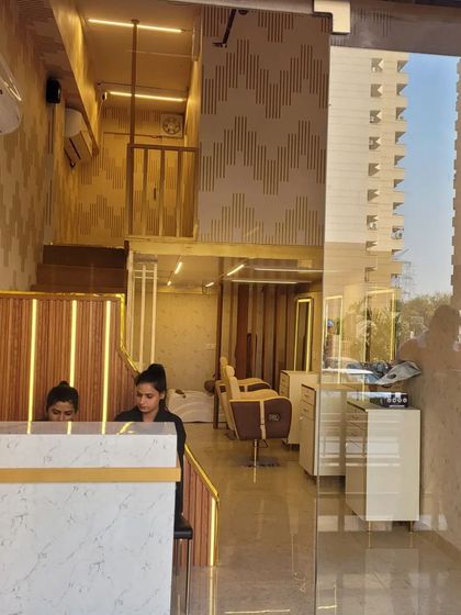 A look through our glass entrance at the reception desk and clean, modern interior. Our staff is always ready to welcome you and assist with your appointment.