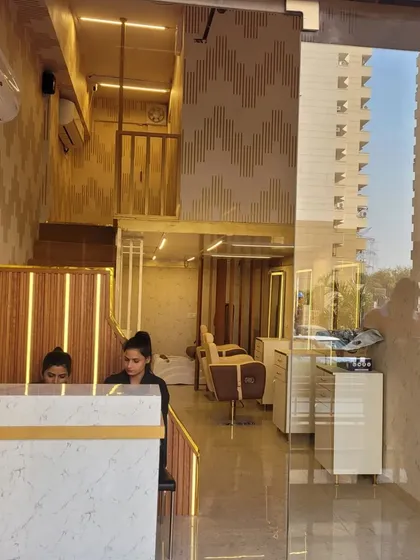 A peek inside our salon from the entrance, showing our reception desk and the clean, modern aesthetic of our interior design.