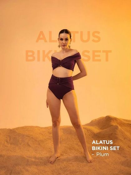 A full-length shot of the Alatus Bikini Set for swimwear brand Tizzi. The warm, gradient background and sand-covered floor were created in-studio to simulate a golden hour beach setting.