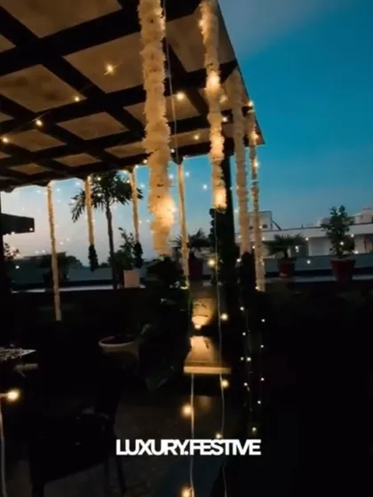 A luxury festive setup. Hanging garlands of 'Ghajra' or jasmine, combined with fairy lights, create an elegant and traditional look for Diwali or other festive parties.