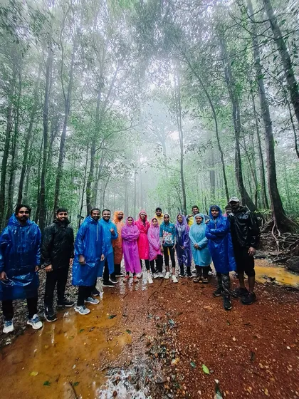 Our group standing together on a muddy trail, surrounded by the dense, foggy forests of Kurinjal. This is an authentic glimpse into the immersive nature of our monsoon treks.