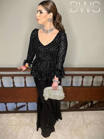 A side profile of the client, showing the length and bounce of her wavy ponytail. This is a perfect party-ready hairstyle.