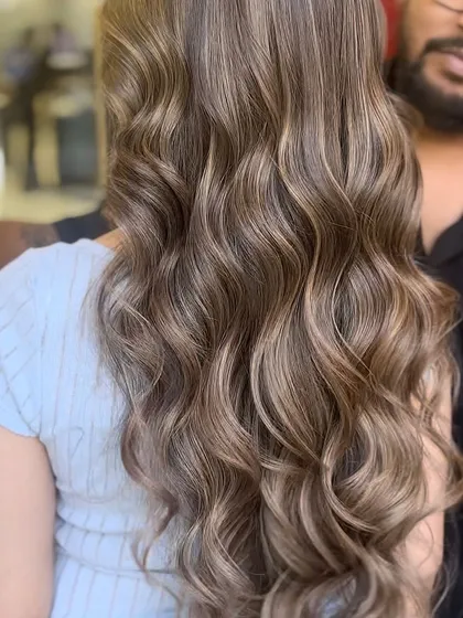 Another angle of the caramel beige balayage, showing how the light catches the different tones. The hair looks healthy, shiny, and full of life.