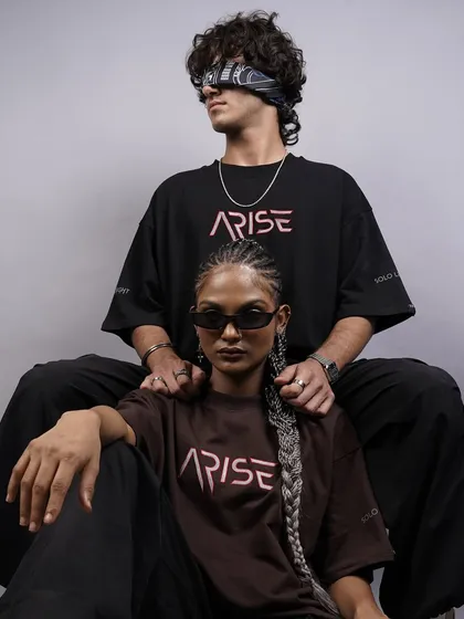 A powerful and intimate shot of two models, highlighting the 'ARISE' logo. The composition and their confident expressions create a strong brand image for this streetwear collection.
