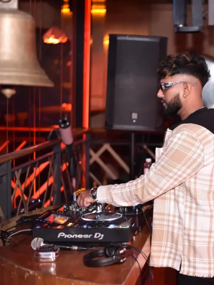 A side view of me at the console, showing the professional Pioneer DJ setup I use for all my gigs.