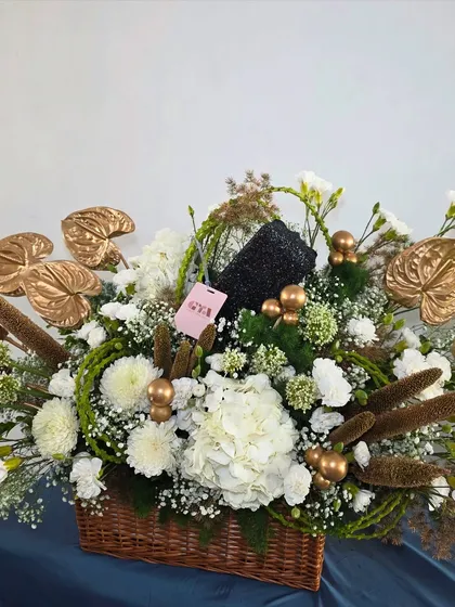 Marking a 50th birthday calls for something truly special. This sophisticated hamper combines pristine white hydrangeas with striking gold-painted anthuriums and other unique botanicals for a modern and celebratory arrangement.