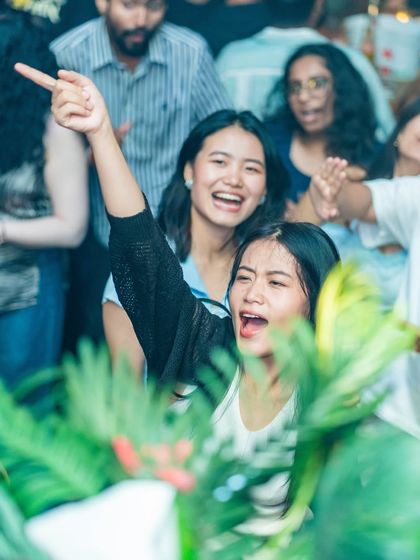 Friends laughing and pointing, having the time of their lives.