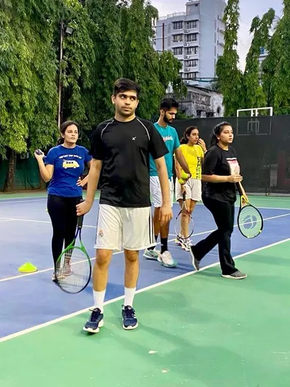 A candid moment during a group lesson. Our sessions are a mix of focused drills, friendly competition, and shared passion for the game.