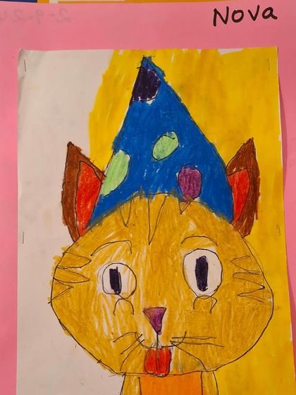 A close-up of the finished cat drawing, showing the student's choice of colors and patterns. We encourage children to make their own creative decisions.