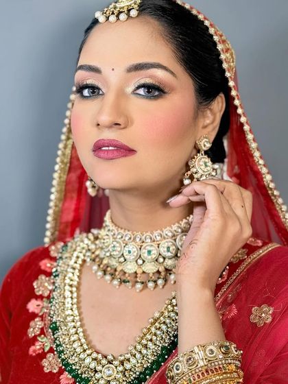 This angle showcases the contouring and highlighting work for a bridal look. The defined cheekbones and brightened under-eyes add dimension to the face, making it look stunning in photos.
