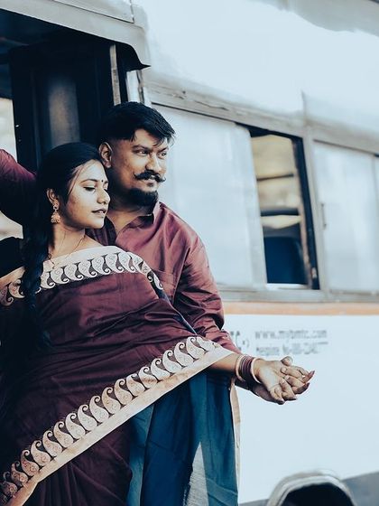 A romantic pose on a bus, capturing the couple's connection with a vintage travel theme.