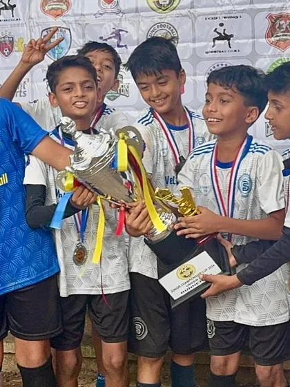 The U11s holding their trophy high. Reaching the semi-finals is a collective achievement for every child, parent, and coach at Bravo.