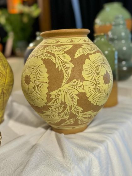 A collection of Prady's finished sgraffito and slip-work pots. His precision with geometric and floral patterns on rounded forms is just incredible.