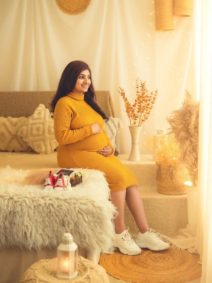 A beautiful, full-length shot of the mom-to-be in our sun-drenched boho studio, creating a warm and happy vibe.