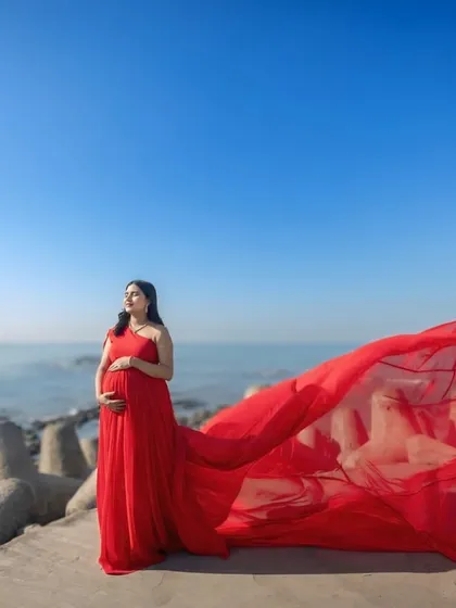 Make a bold statement with our vibrant red infinity gown, captured here against the iconic Mumbai sea link. The flowing georgette fabric is lightweight and creates incredible movement for breathtaking photos.