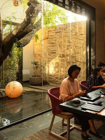 A shot of the biophilic workspace at KEUS, where employees work with a direct view of the central courtyard. This image was part of a feature on rethinking modern workspaces.