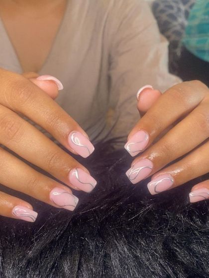 A full view of the abstract chrome art on pink extensions.