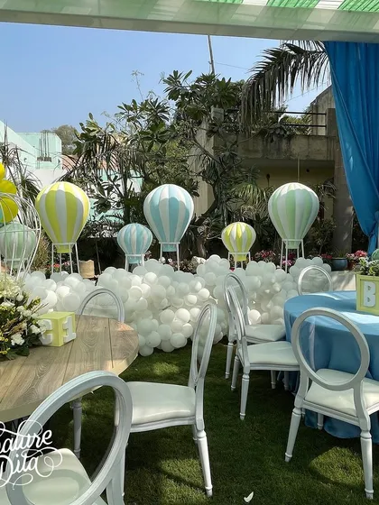 Another view of the baby shower decor, showing the arrangement of tables around the hot air balloon backdrop.