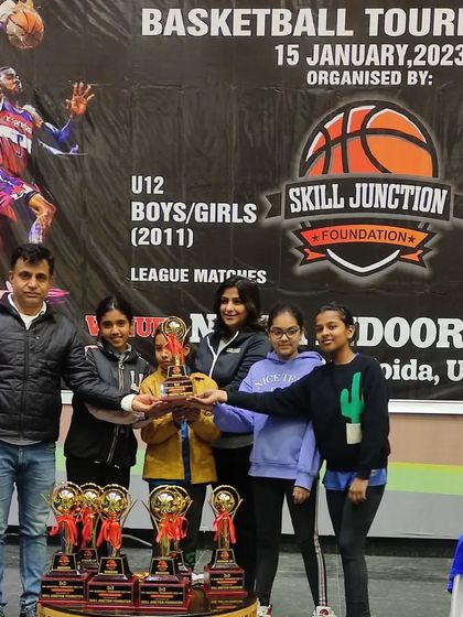 The team with their parents and their well earned trophy. Support from family is a huge part of a player's success.