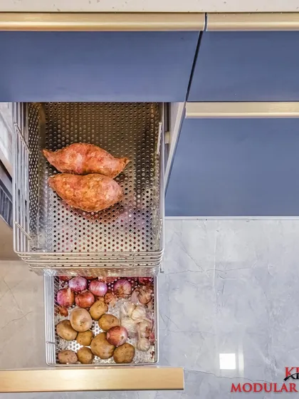 Perforated metal baskets are another great option for vegetable storage, allowing for air circulation to keep produce fresh. This is a durable and modern alternative to wicker.