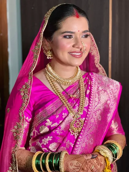 A beautiful three-quarter profile of the bride. Her skin looks flawless and glowing, and the makeup enhances her features without masking her natural beauty.