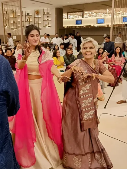 The bride-to-be dancing with her family member is a beautiful sight. These are the candid, happy moments that make an engagement ceremony so special.