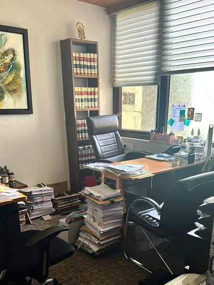 A wider view of my office space, my sanctuary. The piles of paper represent the dedication I pour into each case.
